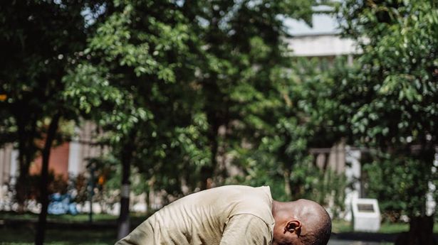 A dynamic motion blur shot of a person doing a bodyweight squat.
