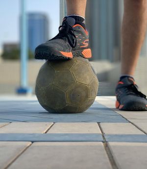 Athlete's feet firmly planted on the ground, showing stability and balance.